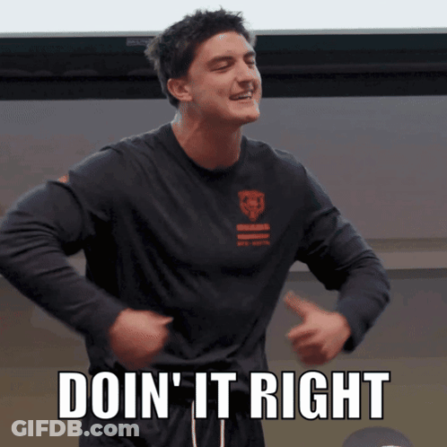 A Man In A Black Shirt With The Words Doin ' It Right On It GIF