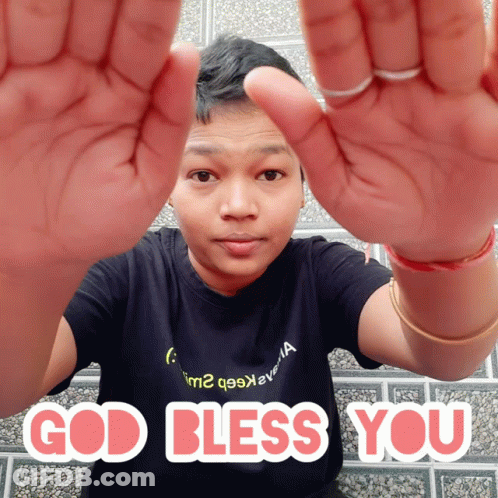 A Man In A Black Shirt With The Words God Bless You Written On It GIF