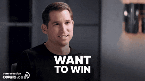 A Man In A Black Shirt With The Words Want To Win Above Him GIF