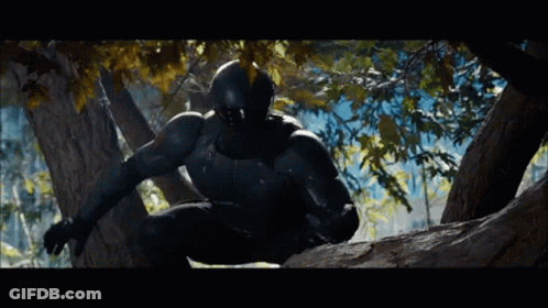 A Man In A Black Suit And Helmet Is Climbing A Tree GIF