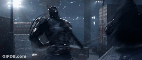 A Man In A Black Suit Is Fighting Another Man GIF