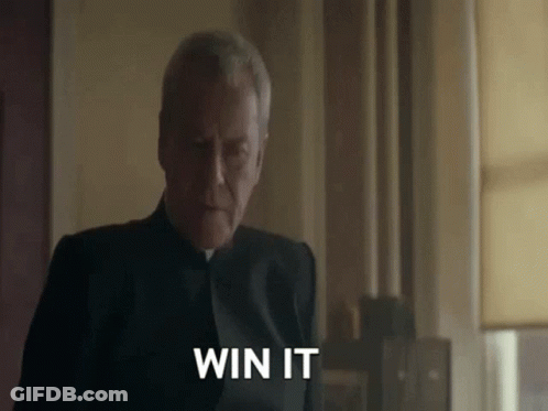 A Man In A Black Suit Is Saying " Win It " GIF