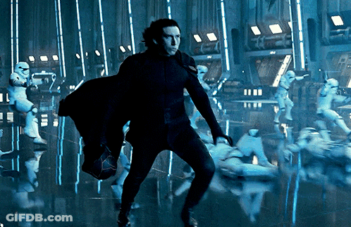 A Man In A Black Suit Is Standing In Front Of A Group Of Stormtroopers GIF