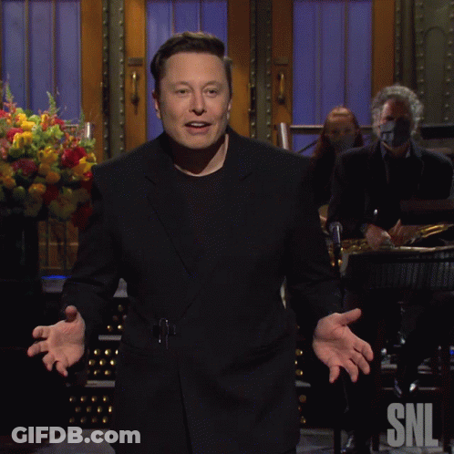 A Man In A Black Suit Is Standing In Front Of A Snl Sign GIF