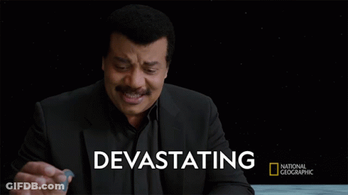 A Man In A Black Suit Stands In Front Of A Black Background With Devastating Written On It GIF