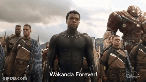 A Man In A Black Suit Stands In Front Of A Group Of Soldiers And The Words Wakanda Forever GIF