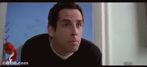 A Man In A Black Sweater Is Making A Funny Face In A Room . GIF