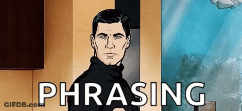 A Man In A Black Sweater Is Standing In Front Of A Wall With The Word Phrasing On It . GIF