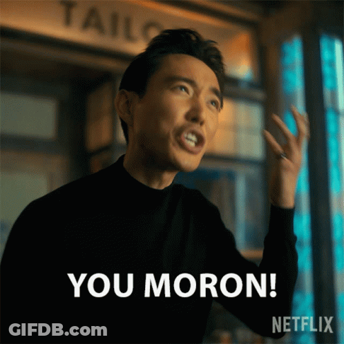 A Man In A Black Sweater Says " You Moron " GIF