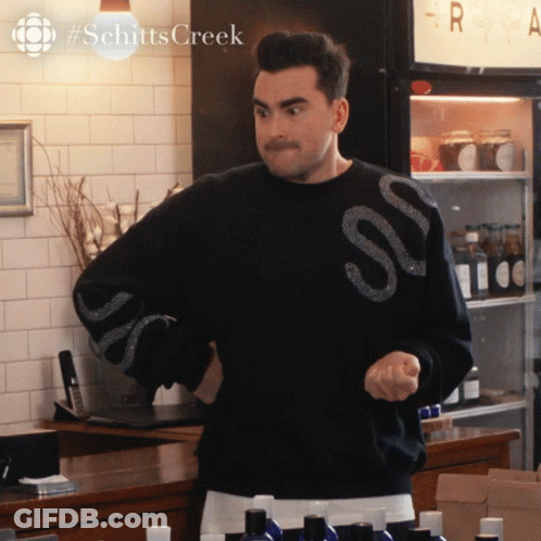 A Man In A Black Sweater With The Word Schitts Creek On It GIF