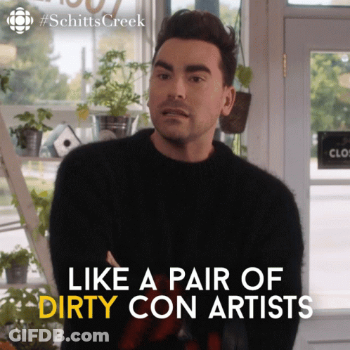 A Man In A Black Sweater With The Words Like A Pair Of Dirty Con Artists On The Bottom GIF