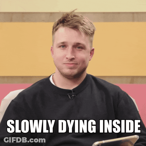 A Man In A Black Sweater With The Words Slowly Dying Inside Above Him GIF