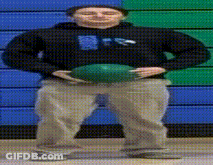 A Man In A Black Sweatshirt Holds A Green Ball In Front Of A Blue And Green Wall GIF