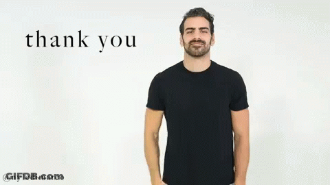 A Man In A Black T-Shirt Is Giving A Thank You Gesture With His Hand . GIF