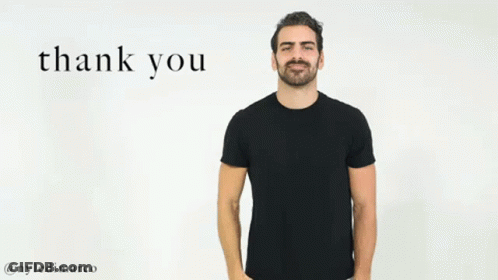 A Man In A Black T-Shirt Is Giving A Thank You Gesture With His Hand . GIF