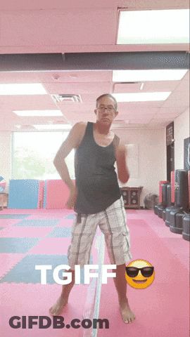 A Man In A Black Tank Top And Plaid Shorts Is Dancing In A Gym With The Words Tgiff Behind Him GIF