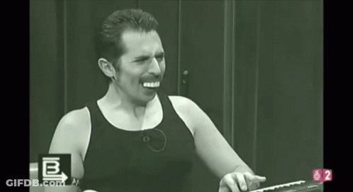 A Man In A Black Tank Top Is Screaming In A Black And White Photo With The Letters B And 2 In The Corner GIF