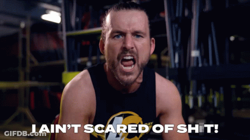 A Man In A Black Tank Top Is Screaming With The Words I Ain 'T Scared Of Shit Below Him GIF