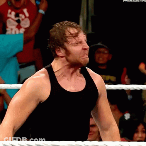 A Man In A Black Tank Top Is Standing In A Wrestling Ring With The Next Thing Written On The Bottom GIF