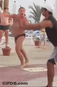 A Man In A Black Tank Top Is Standing Next To A Man In A White Hat . GIF