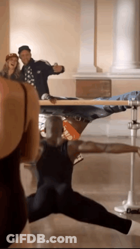 A Man In A Black Tank Top With The Word Elf On The Back Is Dancing GIF