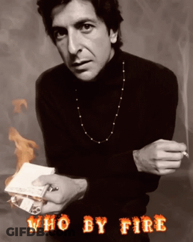 A Man In A Black Turtleneck Is Holding A Cigarette And A Piece Of Paper With The Words Who By Fire Above Him GIF