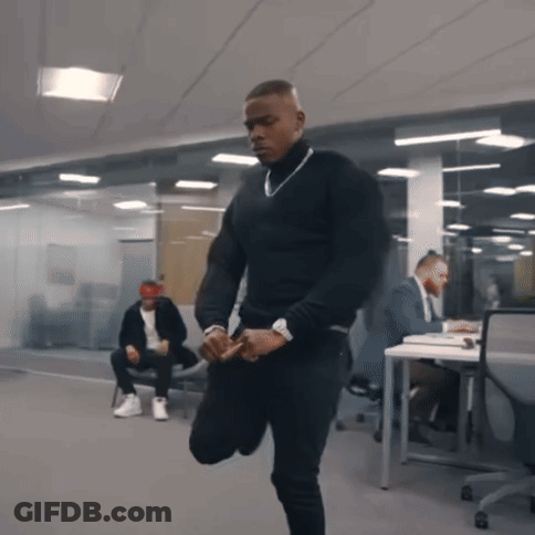 A Man In A Black Turtleneck Sweater Is Kneeling Down GIF