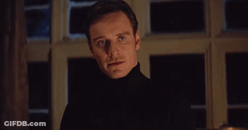 A Man In A Black Turtleneck Sweater Is Standing In Front Of A Window With The Word Perfection Written On The Bottom GIF