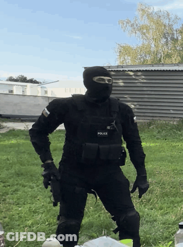 A Man In A Black Uniform With The Word Police On His Chest GIF