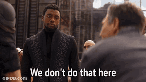A Man In A Black Vest Is Standing In Front Of A Group Of Men And Saying We Don 'T Do That Here . GIF