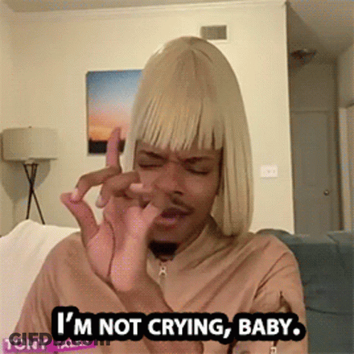 A Man In A Blonde Wig Is Sitting On A Couch And Says I 'M Not Crying Baby GIF