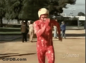 A Man In A Bloody Red Suit And White Helmet Is Running . GIF