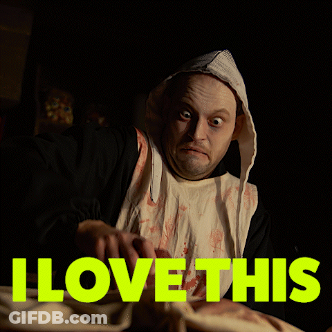 A Man In A Bloody Robe Is Holding A Piece Of Meat With The Words " I Love This " Above Him GIF