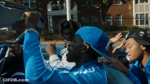A Man In A Blue Adidas Jacket Is Driving A Convertible GIF