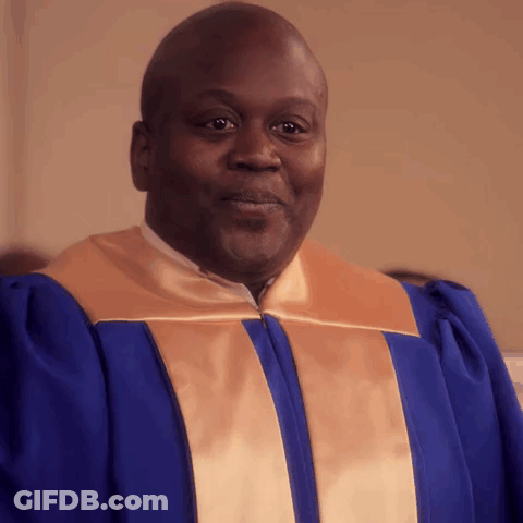 A Man In A Blue And Gold Robe Is Smiling For The Camera GIF