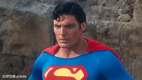 A Man In A Blue And Red Superman Costume GIF