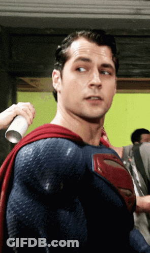 A Man In A Blue And Red Superman Costume GIF