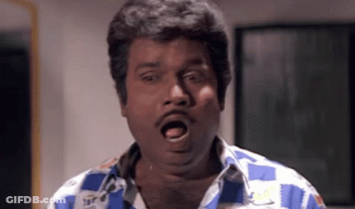 A Man In A Blue And White Checkered Shirt Making A Funny Face GIF