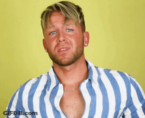 A Man In A Blue And White Striped Shirt Is Making A Face GIF