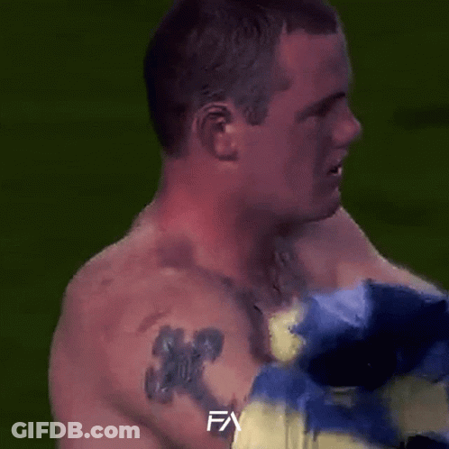 A Man In A Blue And Yellow Striped Shirt With The Letter Fa On The Bottom Right GIF