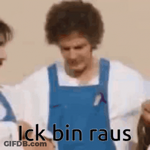 A Man In A Blue Apron Is Standing Next To Another Man In A White Shirt And Says `` Lick Bin Rau '' . GIF
