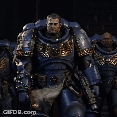 A Man In A Blue Armor With A Skull On The Chest GIF