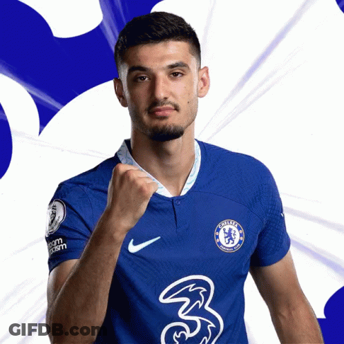A Man In A Blue Chelsea Jersey Holds His Fist Up In The Air GIF