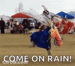 A Man In A Blue Dress Is Dancing In The Rain With The Words Come On Rain Written Below Him . GIF