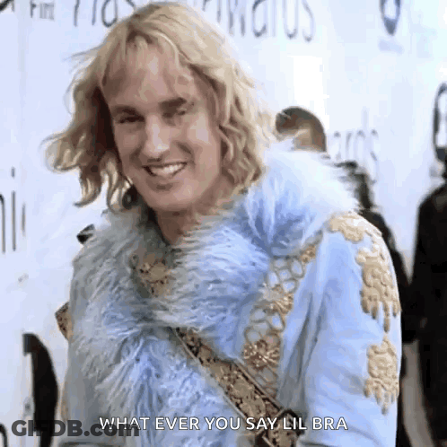 A Man In A Blue Fur Coat Is Smiling And Saying What Ever You Say Lil Bra GIF