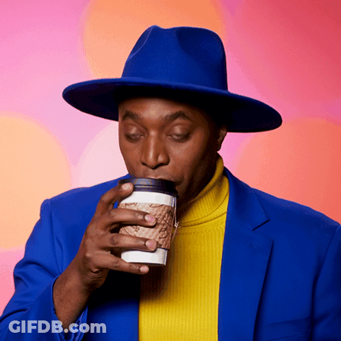 A Man In A Blue Hat Drinking From A Cup GIF