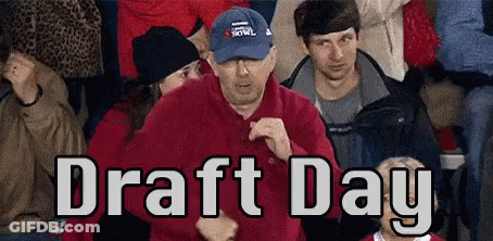 A Man In A Blue Hat Is Dancing In A Crowd Of People With The Words Draft Day Written Above Him GIF
