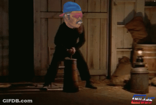 A Man In A Blue Hat Is Holding A Barrel In Front Of A Sign That Says ' Kill ' GIF