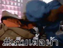 A Man In A Blue Hat Is Laying On A Bed With A Bag On His Head . GIF