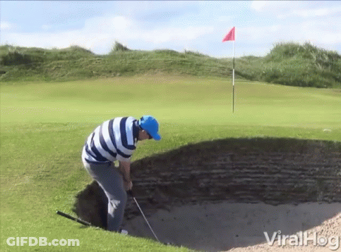 A Man In A Blue Hat Is Playing Golf On A Golf Course GIF